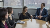 A group of faculty sitting in an conference room having a discussion