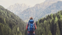 Woman hiking and looking at mountains