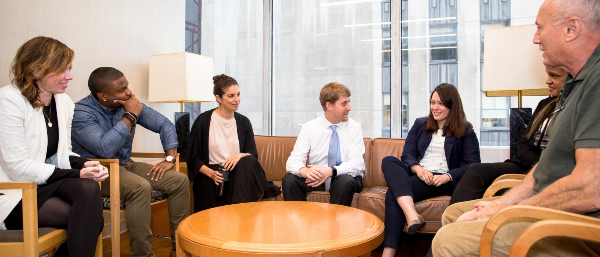 People sitting in a circle talking to one another.