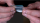 Image of two hands holding a small ziptop bag containing a white powdered substance